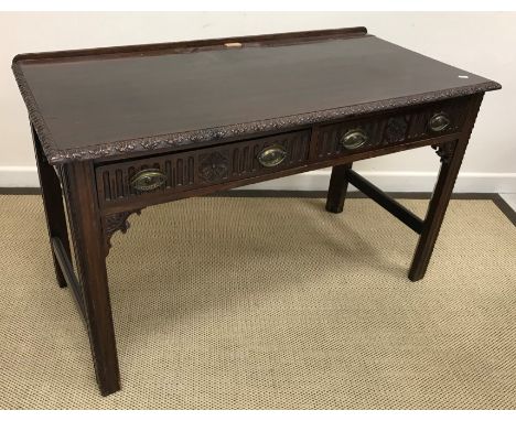 A circa 1900 mahogany side table in the Chippendale taste, the plain top with carved edging over two carved frieze drawers ra