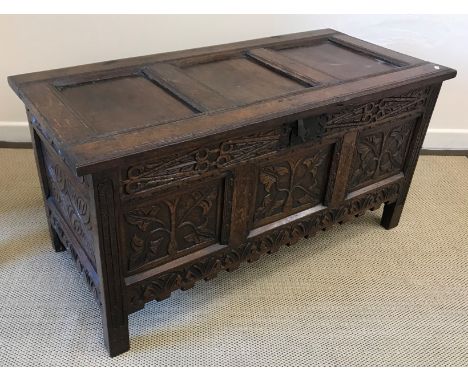 A 17th Century oak coffer, the three panelled top with moulded decoration on original ring hinges opening to reveal a candle 