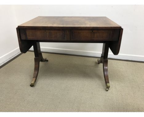 A 19th Century rosewood and cross-banded rounded rectangular drop-leaf sofa table with two frieze drawers, raised on end pill