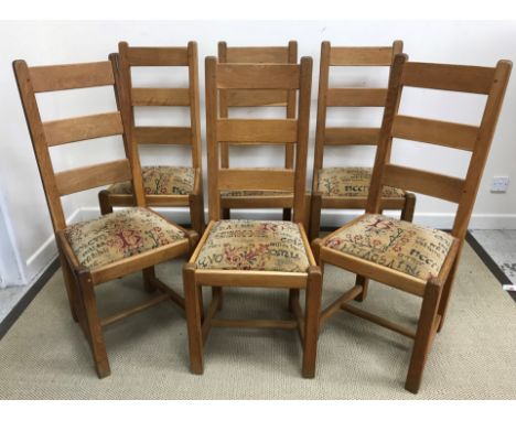 A set of six oak ladder back dining chairs with drop-in upholstered seats