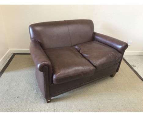 A modern brown leather upholstered "Burlington" two seat scroll arm sofa on square tapered legs in the Edwardian manner, 128 