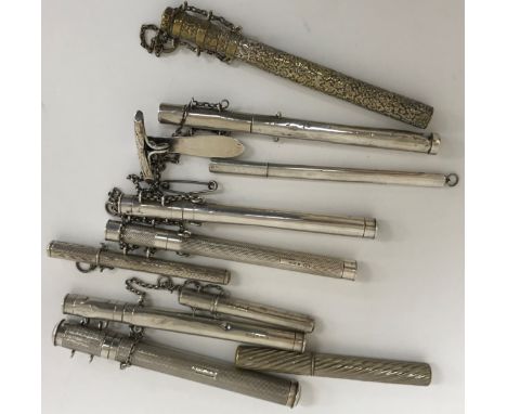 A collection of seven silver pen holders, in varying sizes and designs, to include plain, engine turned and floral decorated,