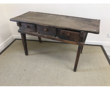 A 19th Century Provincial Spanish walnut side table, the single plank top over three frieze drawers (one a replacement), rais