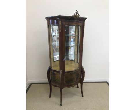 A mahogany vitrine in the Louis XV taste with gilt brass embellishments and Vernis Martin panels, the central door panel deco