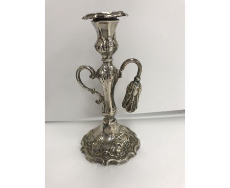 A Victorian silver chamberstick with acanthus leaf decoration and scrolling C handle, on a loaded base (by Henry Wilkinson &a