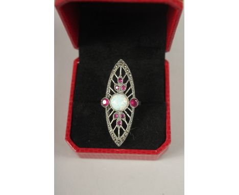 A SILVER OPAL AND RUBY RING.