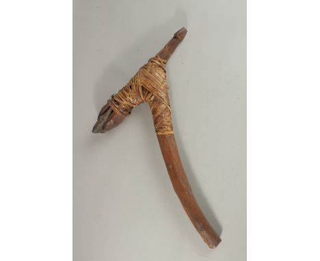 A PAPUA NEW GUINEA WOODEN AND STONE AXE with banding. 43cms high.