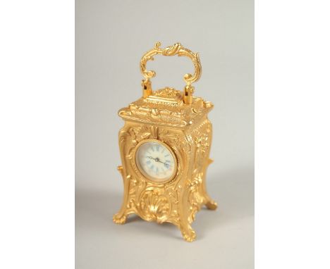 A MINI CAST METAL ORNATE CARRIAGE CLOCK. 7cms high.