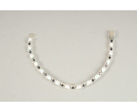 A SILVER OPAL AND SAPPHIRE LINE BRACELET.