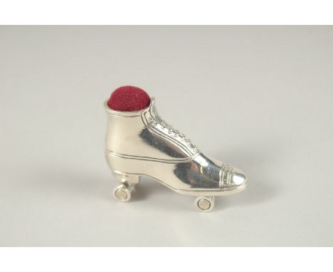 A SILVER PIN CUSHION "ROLLER SKATE".