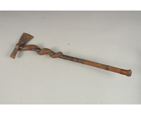 A BRITISH MADE INDIAN TRIBAL AXE with entwined wooden handle. 62cms long.