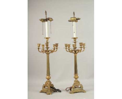 A PAIR OF 19TH CENTURY FIVE-LIGHT BRONZED CANDLESTICKS. 60cms high.