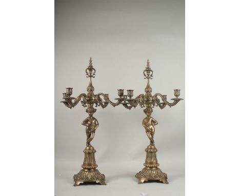 A PAIR OF BRONZE CHERUB FOUR-BRANCH CANDELABRA.