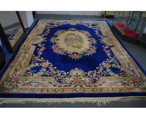 A CHINESE CARPET, blue ground with floral decoration, 380cm x 280cm.
