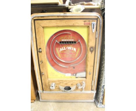 Vintage 'Hawtins All Win' penny slot machine, painted yellow and red in oak-finished case, with ball-bearing action, 68cm hig