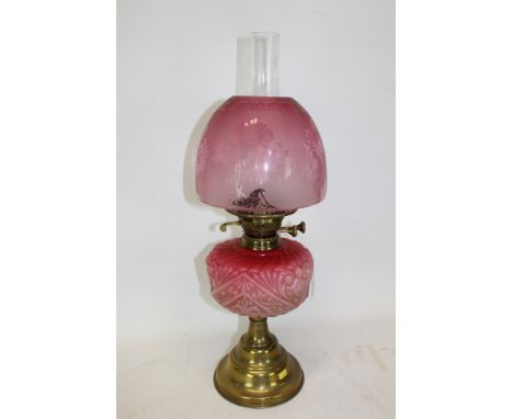 Late 19th / early 20th century oil lamp with brass burner, pink moulded glass reservoir, on a brass-stepped pedestal base, cr