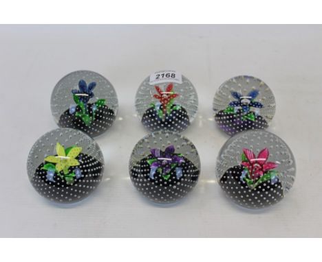 Six Caithness 'Flower In The Rain', 1973 - 1982, glass paperweights, made by Jack Allan