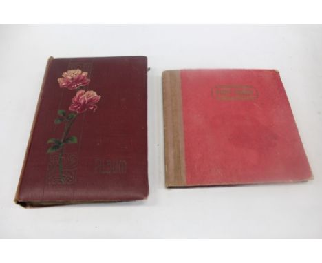Postcards in two albums and loose - including real photographic village and town street scenes, Scout Camp, cyclists and bicy