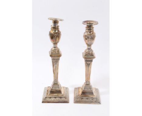 Pair 1930s silver candlesticks in the Georgian classical style, with tapering columns and urn candle holders, festoon and gar