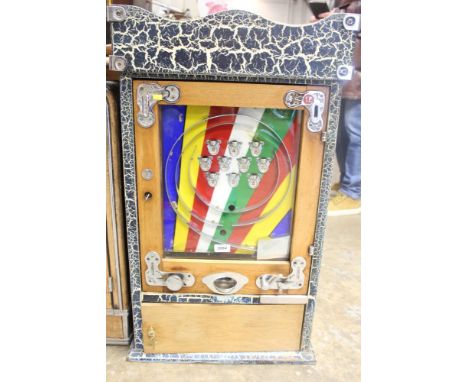 Vintage penny slot machine with multicoloured decoration and ball-bearing action, in oak-finished case, 87cm high CONDITION R