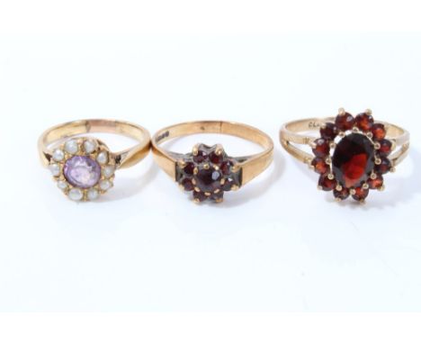 Two gold (9ct) garnet cluster rings and an amethyst and seed pearl ring (3) CONDITION REPORT Two garnet rings 4.9 grams.  Unm