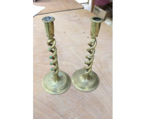 Four pairs brass candlesticks - including one pair with open-twist stems and another with horse and groom decoration, togethe