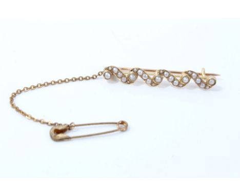 Gold (stamped 15ct) seed pearl bar brooch with safety chain CONDITION REPORT Weight 2.9 grams