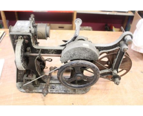 Very early film projector with crank handle