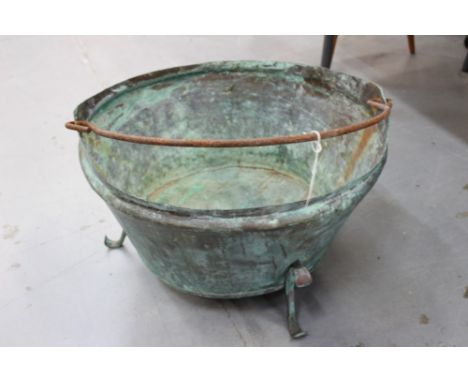 Primitive antique copper vessel of tapered form, with swing handle and bracket feet, together with another, larger with loop 