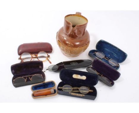 Six pairs of vintage spectacles and an Edwardian silver mounted amber cheroot holder in a fitted case, together with a Victor