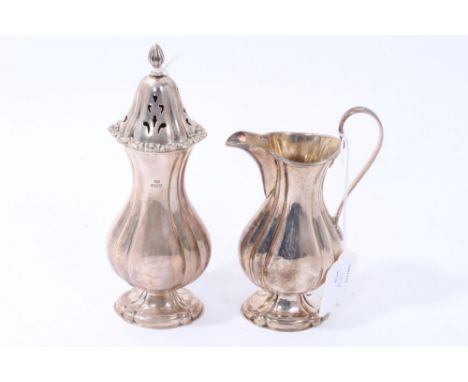 Contemporary silver sugar and cream set - comprising sugar caster of fluted baluster form, with slip-in pierced cover, on a f