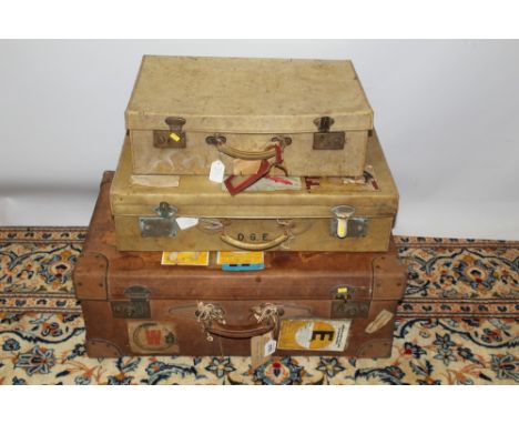Vintage luggage - large leather suitcase (26cm x 70cm x 42cm approximately), with many luggage labels attached, plus two smal