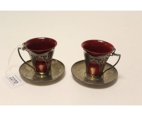 Pair of Art Nouveau silver stylised foliate pierced coffee cups with Royal Doulton flambé liners and pair of matching silver 