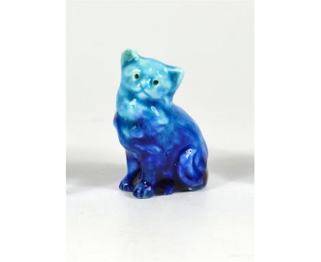 A Bernard Moore miniature model of a cat, covered in a blue glaze. BM monogram inside base. Height 5.5cm.