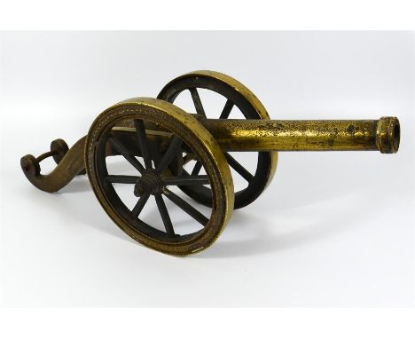 A 19th century cast brass and iron wheeled model cannon. Length 52cm.
