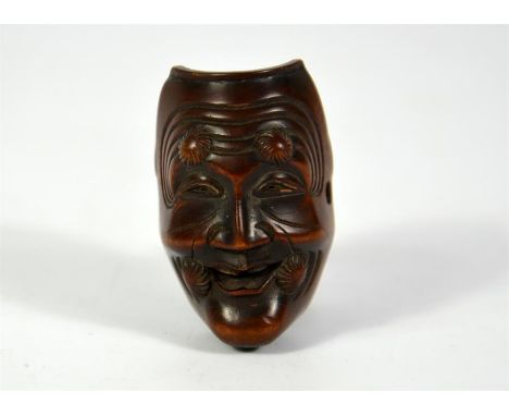 A Japanese boxwood double faced netsuke. One side masked. Height 3.5cm.