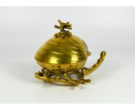 A brass clam shaped inkwell. Circa 1900. Height 12cm.