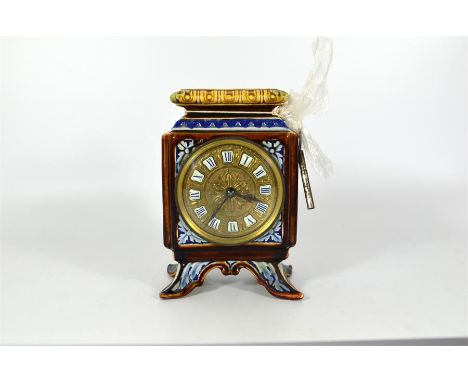A Continental clock in a ceramic case. Height 19cm.