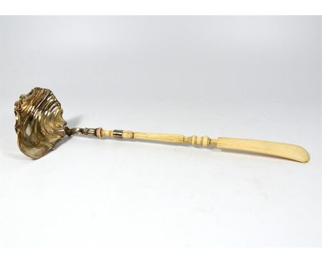 λ A white metal ladle (possibly silver) with a carved ivory handle. Circa 1880.