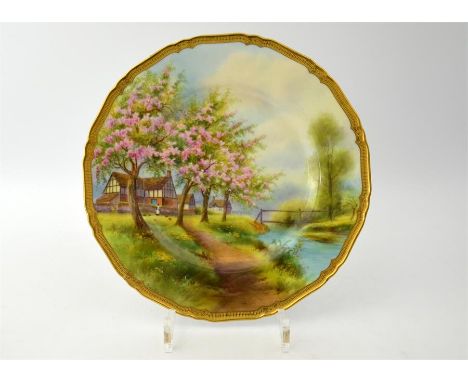 A Royal Worcester plate, painted with apple blossom and rural scene by R Rushton. Date code 1935. Diameter 27.5cm.