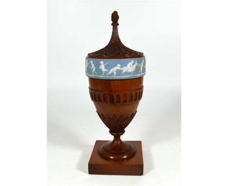 A solid satinwood tea caddy, urn shape decorated with a Wedgwood plaque. Height 28cm.