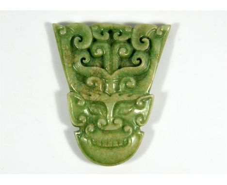 A Chinese jade mask plaque. Height 8cm.