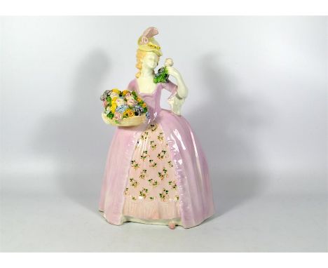 A Goldscheider figure of a lady with a basket of roses. Marked Goldscheider. Height 31.5cm.
