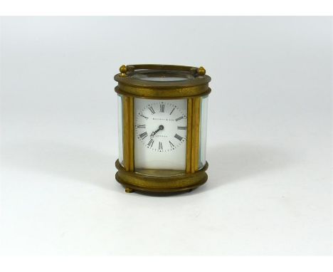 A small brass carriage clock, Elliott & Sons, London. Height 8cm.