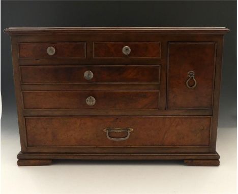 A Chinese hardwood table cabinet of exotic wood construction.19th Century. Having six drawers asymmetrically configured, with