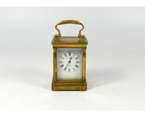 A small brass carriage clock, Elliott & Sons, London. Height 8cm.