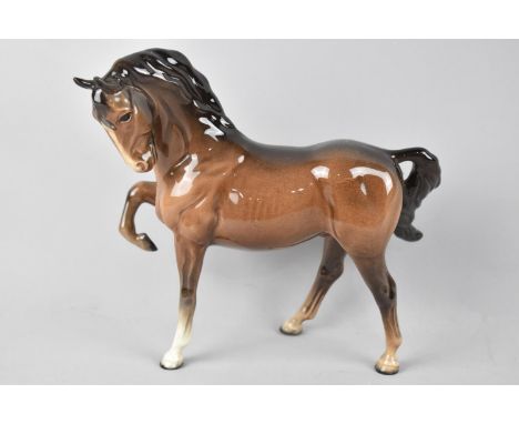 A Beswick Brown Horse Model No. 1549 (Head Tucked, Leg Up), First Version 