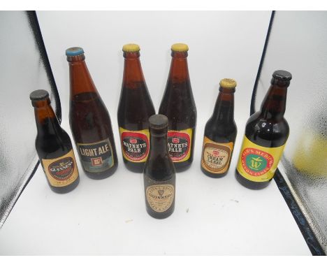 7 Vintage Bottles of Ale etc , Watneys etc ( sold as collectors / display items )