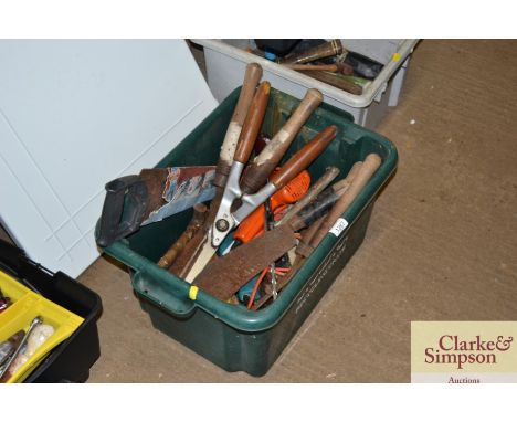 A box containing various tools to include; wood saw, sheers etc.