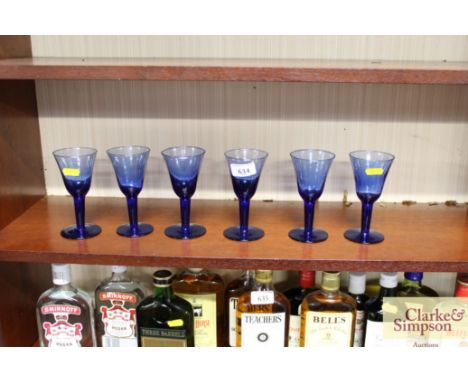 A set of six blue glass wine glasses 